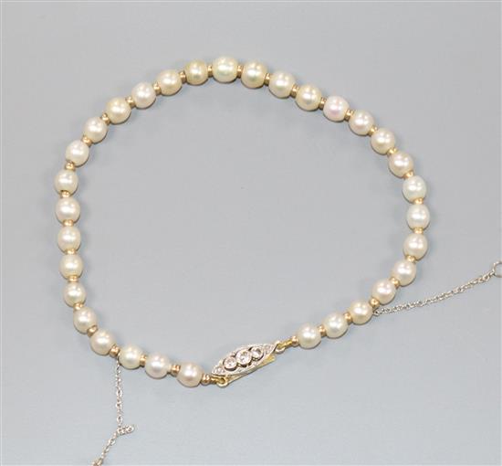 A natural pearl and yellow metal spacer set bracelet with diamond set clasp, 19cm.